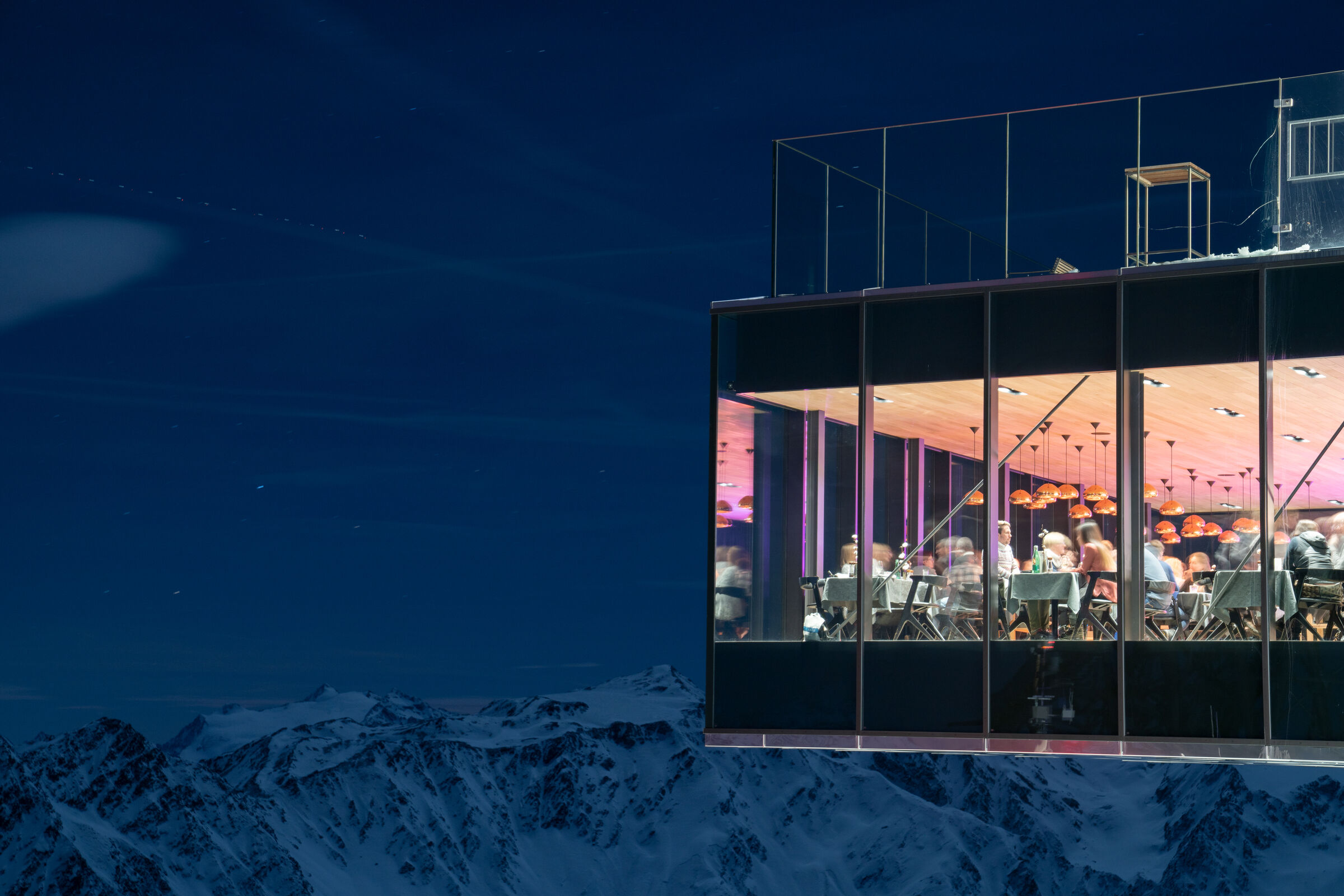 The illuminated ice Q at night above the snowy Ötztal Alps